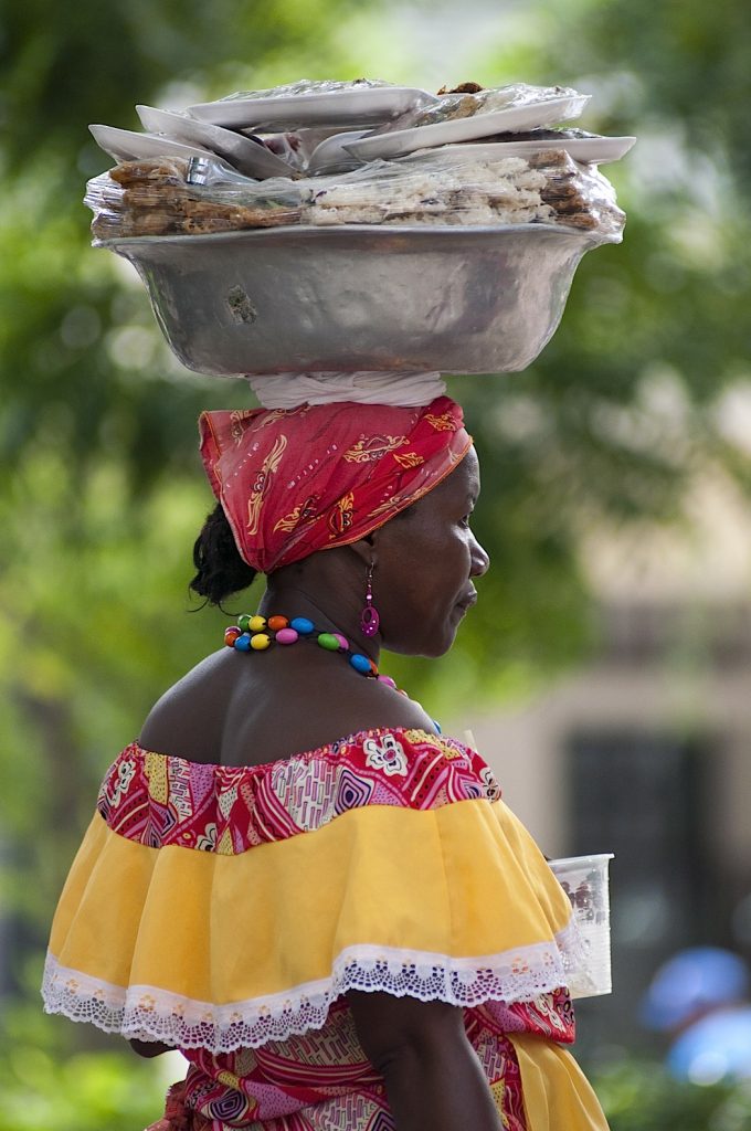 "Palenqueras" are beautiful women that wear colorful dresses and sell fresh fruit or sweets, Cartagena